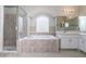 Luxurious bathroom with shower, tub, and tiled accents, offering relaxation and a spa-like experience at 8323 Greystone Dr, Lakeland, FL 33810