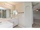 Well-lit bathroom featuring double sink vanity and separate shower area, offering convenience and style at 8323 Greystone Dr, Lakeland, FL 33810