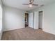 Spacious bedroom with a ceiling fan, closet, and an open doorway to the rest of the house at 8323 Greystone Dr, Lakeland, FL 33810