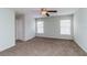 Spacious bedroom with two windows, a ceiling fan, and carpeted floors at 8323 Greystone Dr, Lakeland, FL 33810