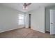 Comfortable bedroom with ceiling fan, neutral walls, and ample closet space, ready for relaxation at 8323 Greystone Dr, Lakeland, FL 33810