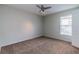Well-lit bedroom with a ceiling fan and a window offering natural light at 8323 Greystone Dr, Lakeland, FL 33810