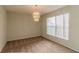 Formal dining room with a modern chandelier and large window providing natural light at 8323 Greystone Dr, Lakeland, FL 33810