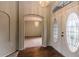 Inviting entryway featuring stylish front doors, hardwood floors, an elegant light fixture, and arched doorways at 8323 Greystone Dr, Lakeland, FL 33810