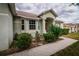 Attractive single Gathering home featuring neat landscaping, a decorative fountain, and a covered front entry at 8323 Greystone Dr, Lakeland, FL 33810