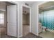 Hallway featuring entry to a bedroom and a full bathroom with a shower and tub at 8323 Greystone Dr, Lakeland, FL 33810