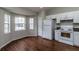 Bright kitchen with white cabinets, appliances, and wood floors, ideal for cooking at 8323 Greystone Dr, Lakeland, FL 33810