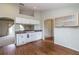 Bright kitchen featuring white cabinets, wood floors, and convenient breakfast bar for casual dining at 8323 Greystone Dr, Lakeland, FL 33810