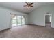 Bright living room with sliding glass doors leading to the backyard and neutral carpeting throughout at 8323 Greystone Dr, Lakeland, FL 33810