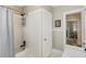 Bright bathroom with a white tiled shower/tub combination and classic fixtures at 838 S Tennessee Ave, Lakeland, FL 33801