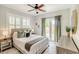 Comfortable bedroom with french doors, a ceiling fan and stylish accents at 838 S Tennessee Ave, Lakeland, FL 33801