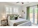 Comfortable bedroom with french doors, a ceiling fan and stylish accents at 838 S Tennessee Ave, Lakeland, FL 33801