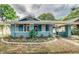 Charming home featuring a covered porch, manicured landscaping, and a driveway at 838 S Tennessee Ave, Lakeland, FL 33801
