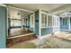 Inviting front porch with a covered area, brick steps, and decorative plants at 838 S Tennessee Ave, Lakeland, FL 33801