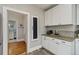 Bright kitchen area featuring white cabinetry and modern appliances, with an adjacent bathroom view at 838 S Tennessee Ave, Lakeland, FL 33801