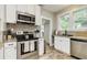 Modern kitchen with stainless steel appliances, white cabinets, and sleek granite countertops at 838 S Tennessee Ave, Lakeland, FL 33801