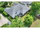 Aerial view of house showcasing the backyard, patio area, mature trees, and landscaping at 1145 Denton St, Lakeland, FL 33803