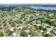 An aerial view showcasing a residential community with tree-lined streets and a nearby lake at 1145 Denton St, Lakeland, FL 33803