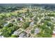 Expansive aerial view of the neighborhood with lush green landscaping and nearby golf course and community tennis courts at 1145 Denton St, Lakeland, FL 33803