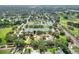 Beautiful aerial view of community park featuring tennis courts, playground, and green spaces nearby a golf course at 1145 Denton St, Lakeland, FL 33803