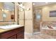 Well-appointed bathroom with tiled shower, soaking tub, and granite countertops at 1145 Denton St, Lakeland, FL 33803