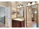 Bright bathroom featuring a large mirror, vanity, and tile flooring at 1145 Denton St, Lakeland, FL 33803