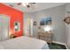 Cozy bedroom with colorful wall, artwork, and views into connecting room at 1145 Denton St, Lakeland, FL 33803