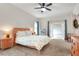 Comfortable bedroom with carpet flooring, ceiling fan, and access to a sunroom at 1145 Denton St, Lakeland, FL 33803