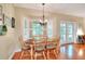 Bright dining area with a round table, plantation shutters, and easy access to the outdoors at 1145 Denton St, Lakeland, FL 33803