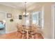 Charming dining area with a round wooden table and bay window with plantation shutters at 1145 Denton St, Lakeland, FL 33803