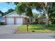 Charming single-story home featuring a brick facade, well-maintained lawn and mature landscaping at 1145 Denton St, Lakeland, FL 33803