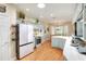 Bright kitchen featuring stainless steel appliances, hardwood floors, and adjacent dining area at 1145 Denton St, Lakeland, FL 33803