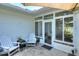 Outdoor patio with white Adirondack chairs and enclosed screened area at 1145 Denton St, Lakeland, FL 33803
