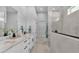 Bright bathroom featuring double vanity, marble countertop, sleek black hardware and an enclosed glass shower at 1170 Windjammer Dr, Lakeland, FL 33803