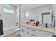 Bright bathroom with white tiling, double vanity with marble countertops, and an enclosed shower and bathtub at 1170 Windjammer Dr, Lakeland, FL 33803