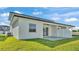 Back exterior of home featuring well manicured lawn and private patio at 1170 Windjammer Dr, Lakeland, FL 33803