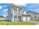 Modern townhome showcasing pristine landscaping, light gray paint, and a two-car garage at 1170 Windjammer Dr, Lakeland, FL 33803