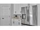 Modern kitchen with stainless steel refrigerator and white cabinets providing ample storage space at 1170 Windjammer Dr, Lakeland, FL 33803