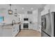 Clean modern kitchen with stainless steel appliances, white cabinetry, pendant lighting and granite countertops at 1170 Windjammer Dr, Lakeland, FL 33803