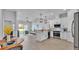 Bright and open kitchen with a farmhouse sink, stainless steel appliances, and an adjacent living area at 1170 Windjammer Dr, Lakeland, FL 33803