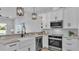 Bright kitchen featuring white cabinets, modern appliances, granite countertops, and a stainless steel dishwasher at 1170 Windjammer Dr, Lakeland, FL 33803