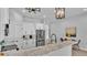 Open kitchen featuring stainless steel refrigerator, marble countertops, and modern lighting fixtures at 1170 Windjammer Dr, Lakeland, FL 33803