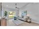 Bright living room with modern furnishings, sliding glass doors, and neutral decor at 1170 Windjammer Dr, Lakeland, FL 33803