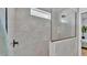 Modern shower featuring light textured tile, a rainfall shower head and a glass enclosure at 1170 Windjammer Dr, Lakeland, FL 33803