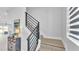 Modern staircase with black horizontal railings and bright treads leading upstairs with large window at 1170 Windjammer Dr, Lakeland, FL 33803