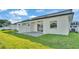 The backyard features a grass lawn and a concrete paver patio with sliding glass door entry at 1172 Windjammer Dr, Lakeland, FL 33803