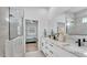 Spacious bathroom with dual sinks, large mirror, glass enclosed shower and bedroom access at 1172 Windjammer Dr, Lakeland, FL 33803