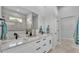 Bright, clean bathroom featuring dual sinks, marble counters and black hardware at 1172 Windjammer Dr, Lakeland, FL 33803
