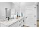Bright bathroom featuring dual sinks, marble counters and black hardware at 1172 Windjammer Dr, Lakeland, FL 33803