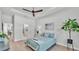 Comfortable bedroom featuring a ceiling fan, tray ceiling, and ample natural light at 1172 Windjammer Dr, Lakeland, FL 33803